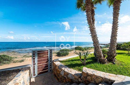 Punta Prima Apartment | Beachfront Bliss apt, with heated pool, by OYOOSTAYS