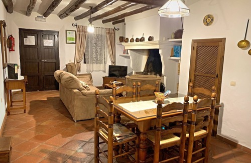 Zahara de la Sierra Cottage | Cozy House in Zahara de la Sierra, Cádiz: Fireplace and Castle Views