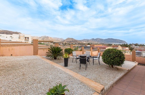 Isla Plana Apartment | Enjoy a relaxing vacation by the sea in this vacation apartment with a beautiful conservatory.