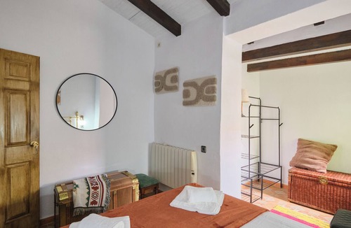 Arenas del Rey Bed & Breakfast | Luxury bedroom in Los Bermejales with a view of the pool.