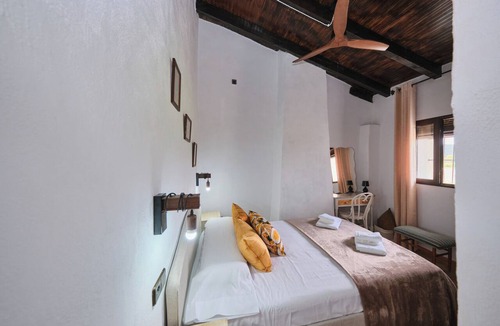 Arenas del Rey Bed & Breakfast | Luxury bedroom in Tejeda with a view of Lake Bermejales.