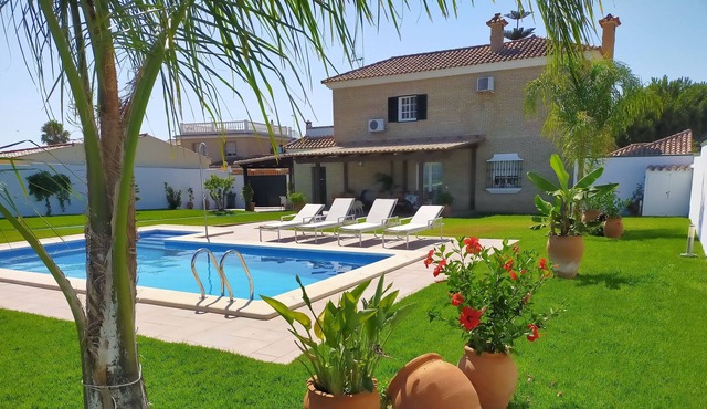 House with tennis court and pool next to the beach